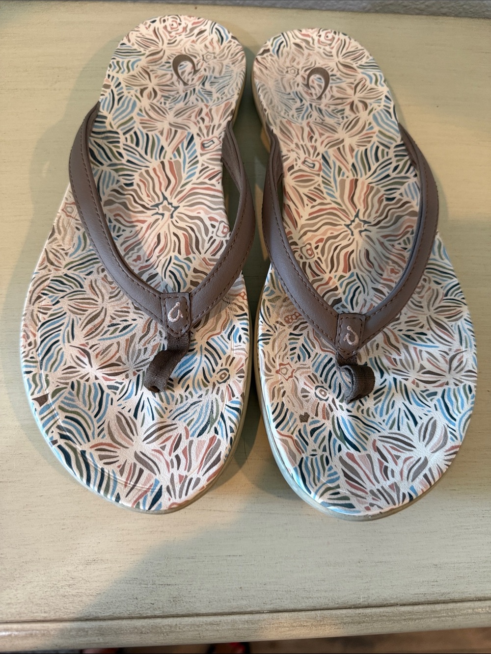 OluKai Women's Floral Print Flip Flops in Brown Cream with Blue Accents #1000-1